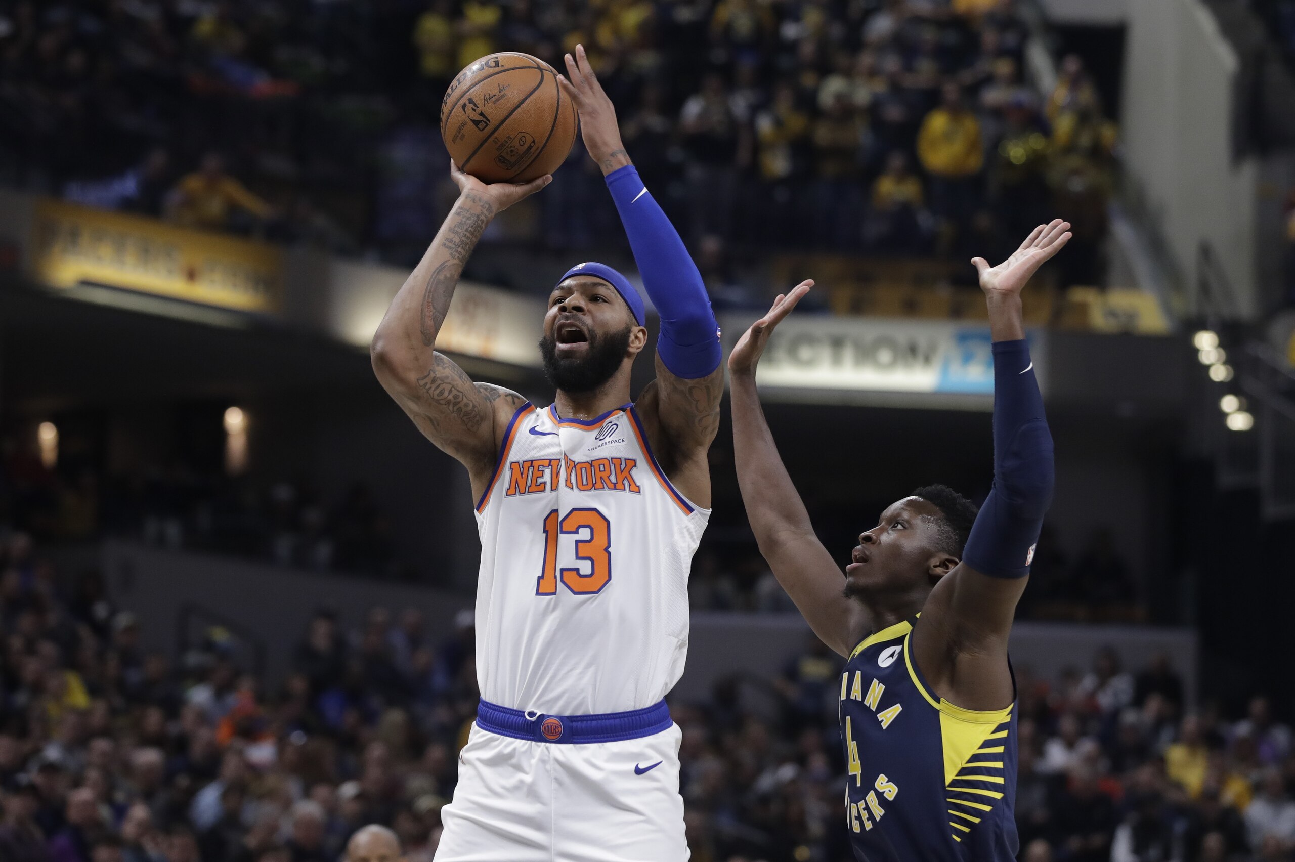 New York Knicks' Marcus Morris Sr. (13) shoots against Indiana Pacers' Victor Oladipo (4) during the first half of an NBA basketball game, Saturday, Feb. 1, 2020, in Indianapolis. (AP Photo/Darron Cummings)