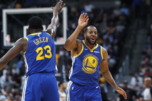 Golden State Warriors forward Draymond Green, left, congratulates guard Andre Iguodala after his dunk against the Denver Nuggets in the second half of an NBA basketball game, Tuesday, Jan. 15, 2019, in Denver. The Warriors won 142-111. (AP Photo/David Zalubowski)