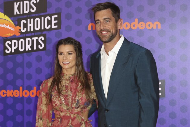 NFL football player Aaron Rodgers, of the Green Bay Packers, right, and Danica Patrick arrive at the Kids' Choice Sports Awards at the Barker Hangar on Thursday, July 19, 2018, in Santa Monica, Calif. (Photo by Willy Sanjuan/Invision/AP)
