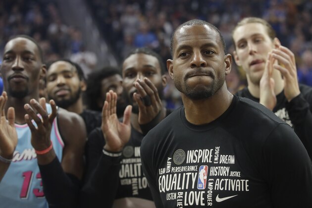 Teammates applaud during a video tribute to Miami Heat guard Andre Iguodala, foreground, before an NBA basketball game between the Golden State Warriors and the Heat in San Francisco, Monday, Feb. 10, 2020. (AP Photo/Jeff Chiu)