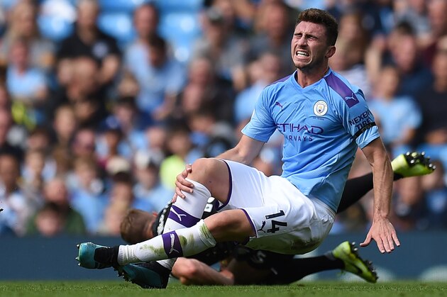 Manchester City's French defender Aymeric Laporte picks up an injury in a challenge with Brighton's English defender Adam Webster during the English Premier League football match between Manchester City and Brighton and Hove Albion at the Etihad Stadium in Manchester, north west England, on August 31, 2019. (Photo by Oli SCARFF / AFP) / RESTRICTED TO EDITORIAL USE. No use with unauthorized audio, video, data, fixture lists, club/league logos or 'live' services. Online in-match use limited to 120 images. An additional 40 images may be used in extra time. No video emulation. Social media in-match use limited to 120 images. An additional 40 images may be used in extra time. No use in betting publications, games or single club/league/player publications. /         (Photo credit should read OLI SCARFF/AFP via Getty Images)