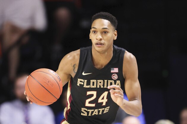 Florida State guard Devin Vassell (24) dribbles up court against Florida during the first half of an NCAA college basketball game Sunday, Nov. 10, 2019, in Gainesville, Fla. (AP Photo/Matt Stamey)