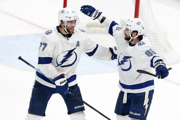 Tampa Bay Lightning forward Nikita Kucherov, right, of Russia, celebrates his game-winning goal against the Columbus Blue Jackets with teammate defenseman Victor Hedman, of Sweden, during overtime of an NHL hockey game in Columbus, Ohio, Monday, Feb. 10, 2020. The Lightning won 2-1. (AP Photo/Paul Vernon)