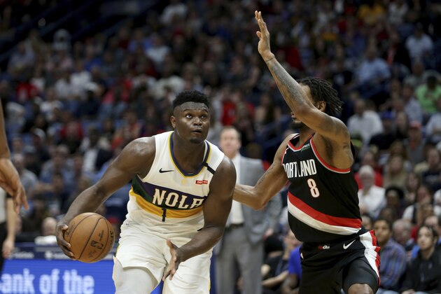 New Orleans Pelicans forward Zion Williamson (1) dribbles the ball as Portland Trail Blazers forward Trevor Ariza (8) defends in the first half of an NBA basketball game in New Orleans, Tuesday, Feb. 11, 2020. (AP Photo/Rusty Costanza) New Orleans Pelicans forward Zion Williamson (1) dribbles the ball as Portland Trail Blazers forward Trevor Ariza (8) defends in the first half of an NBA basketball game in New Orleans, Tuesday, Feb. 11, 2020. (AP Photo/Rusty Costanza)