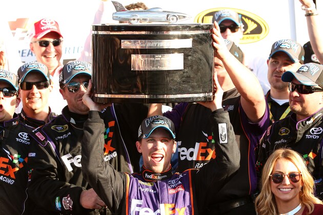 DAYTONA BEACH, FL - FEBRUARY 21:  Denny Hamlin, driver of the #11 FedEx Express Toyota, celebrates with the Harley J. Earl Trophy in Victory Lane after winning the NASCAR Sprint Cup Series DAYTONA 500 at Daytona International Speedway on February 21, 2016 in Daytona Beach, Florida.  (Photo by Chris Graythen/Getty Images)