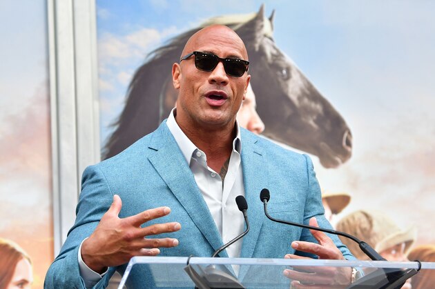 Actor Dwayne Johnson speaks at Kevin Hart's Hand and Footprints ceremony in Hollywood, California on December 10, 2019. (Photo by Frederic J. BROWN / AFP) (Photo by FREDERIC J. BROWN/AFP via Getty Images)