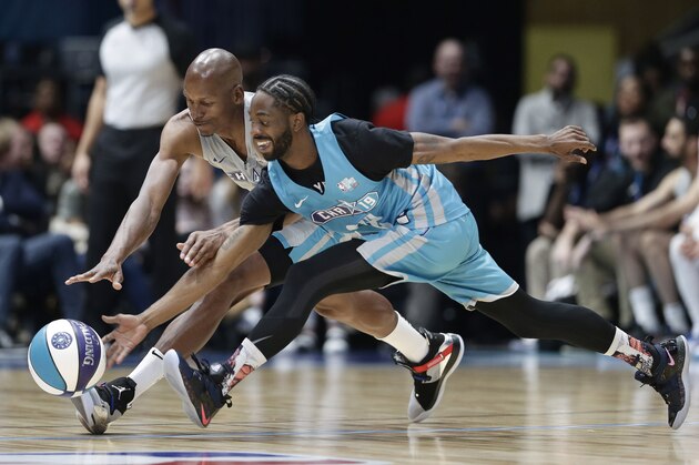 Home team's Famous Los, right, and Away team's Ray Allen chase the ball during the first half of an NBA All-Star Celebrity basketball game in Charlotte, N.C., Friday, Feb. 15, 2019. (AP Photo/Gerry Broome)