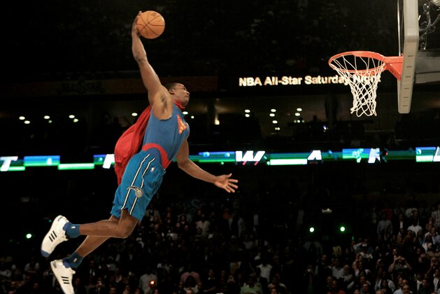 Wearing a Superman costume, Orlando Magic forward Dwight Howard soars toward the basket in the basketball slam dunk contest Saturday, Feb. 16, 2008, at the NBA All Star Weekend in New Orleans. (AP Photo/Eric Gay)