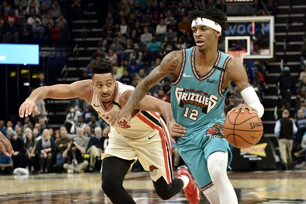 Memphis Grizzlies guard Ja Morant (12) drives ahead of Portland Trail Blazers guard CJ McCollum (3) during the second half of an NBA basketball game Wednesday, Feb. 12, 2020, in Memphis, Tenn. (AP Photo/Brandon Dill)