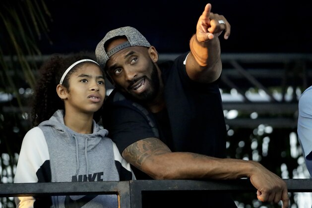 Former Los Angeles Laker Kobe Bryant and his daughter Gianna watch the U.S. national championships swimming meet Thursday, July 26, 2018, in Irvine, Calif. (AP Photo/Chris Carlson)