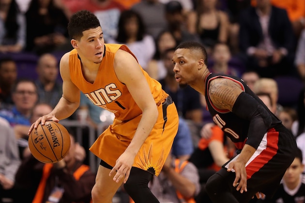 PHOENIX, AZ - MARCH 12:  Devin Booker #1 of the Phoenix Suns handles the ball against Damian Lillard #0 of the Portland Trail Blazers during the NBA game at Talking Stick Resort Arena on March 12, 2017 in Phoenix, Arizona.   The Trailblazers defeated the Suns 110-101.  NOTE TO USER: User expressly acknowledges and agrees that, by downloading and or using this photograph, User is consenting to the terms and conditions of the Getty Images License Agreement.  (Photo by Christian Petersen/Getty Images)