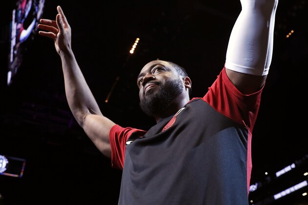 FILE - In this Wednesday, April 10, 2019, file photo, Miami Heat guard Dwyane Wade (3) acknowledges cheers from the crowd before the start of the final NBA basketball game of his career, against the Brooklyn Nets in New York. William Morrow announced Wednesday, June 5, 2019, that Wade, who retired at the end of the 2018-2019 season, has a memoir coming out called “3 Dimensional,” scheduled for release in October. (AP Photo/Kathy Willens, File)