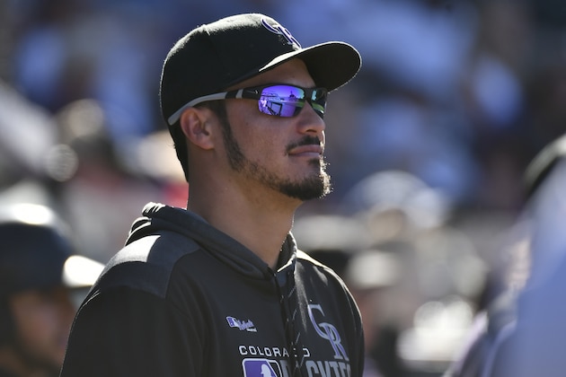 Colorado Rockies third baseman Nolan Arenado (28) looks on from the dugout during a baseball game against the Milwaukee Brewers, Sunday, Sept. 29, 2019, in Denver. (AP Photo/John Leyba)
