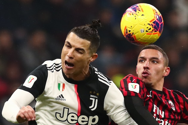 Juventus' Portuguese forward Cristiano Ronaldo (L) and AC Milan's Algerian defender Ismael Bennacer go for a header during the Italian Cup (Coppa Italia) semi-final first leg football match AC Milan vs Juventus Turin on February 13, 2020 at the San Siro stadium in Milan. (Photo by Isabella BONOTTO / AFP) (Photo by ISABELLA BONOTTO/AFP via Getty Images)