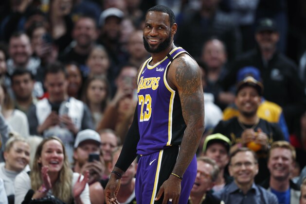 Los Angeles Lakers forward LeBron James laughs after getting heckled by a spectator in overtime of the team's NBA basketball game against the Denver Nuggets on Wednesday, Feb. 12, 2020, in Denver. The Lakers won 120-116. (AP Photo/David Zalubowski)