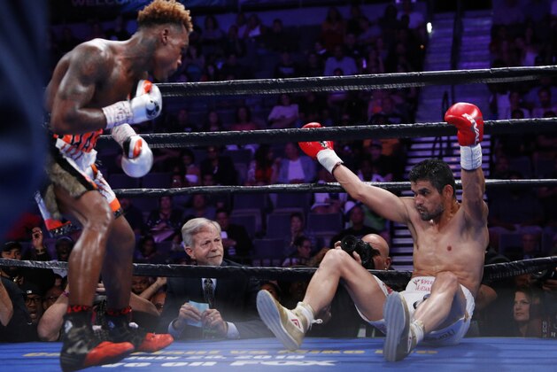 Jermell Charlo knocks down Jorge Cota, of Mexico, in a junior middleweight boxing match Sunday, June 23, 2019, in Las Vegas. (AP Photo/John Locher)