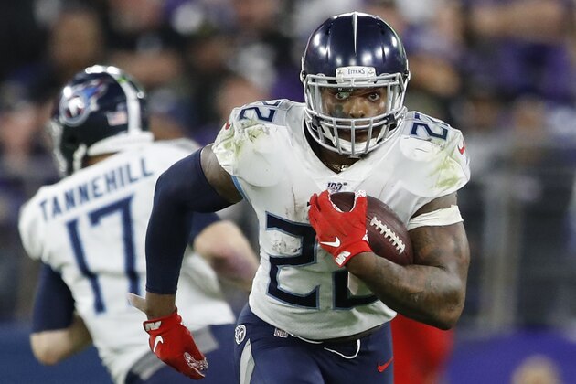 Tennessee Titans running back Derrick Henry (22) runs past Baltimore Ravens players during the second half of an NFL divisional playoff football game, Saturday, Jan. 11, 2020, in Baltimore. (AP Photo/Julio Cortez)