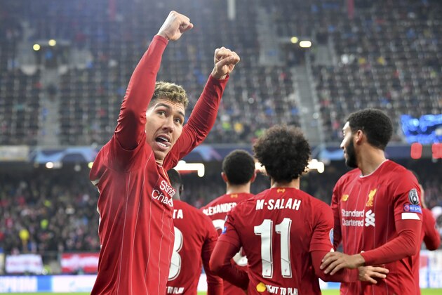 Liverpool's Roberto Firmino, left, celebrates after Liverpool's Mohamed Salah scored his side's second goal during the group E Champions League soccer match between Salzburg and Liverpool, in Salzburg, Austria, Tuesday, Dec. 10, 2019. (AP Photo/Kerstin Joensson)