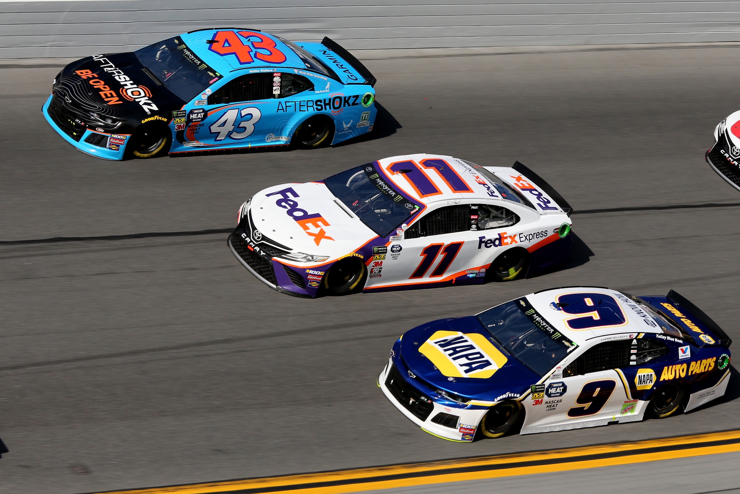 DAYTONA BEACH, FL - FEBRUARY 17:  Bubba Wallace, driver of the #43 Aftershokz Chevrolet, Denny Hamlin, driver of the #11 FedEx Express Toyota, and Chase Elliott, driver of the #9 NAPA Auto Parts Chevrolet, race during the Monster Energy NASCAR Cup Series 61st Annual Daytona 500 at Daytona International Speedway on February 17, 2019 in Daytona Beach, Florida.  (Photo by Jerry Markland/Getty Images)