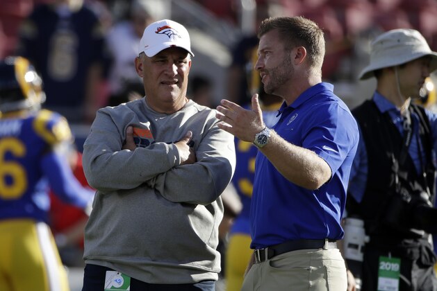 Los Angeles Rams head coach Sean McVay, right, talks to Denver Broncos head coach Vic Fangio before the start of an NFL preseason football game Saturday, Aug. 24, 2019, in Los Angeles. (AP Photo/Rick Scuteri)