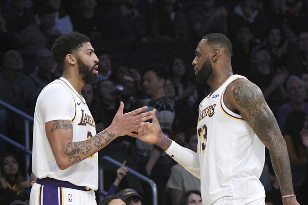 Los Angeles Lakers forward Anthony Davis, left, slaps hands with guard LeBron James during an NBA basketball game against the Dallas Mavericks Sunday, Dec. 29, 2019, in Los Angeles. (AP Photo/Michael Owen Baker) Los Angeles Lakers forward Anthony Davis, left, slaps hands with guard LeBron James during an NBA basketball game against the Dallas Mavericks Sunday, Dec. 29, 2019, in Los Angeles. (AP Photo/Michael Owen Baker)