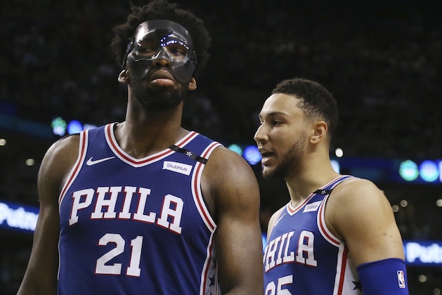 Philadelphia 76ers center Joel Embiid (21) and guard Ben Simmons (25) have words during a break in the fourth quarter of Game 2 of an NBA basketball second-round playoff series against the Boston Celtics, Thursday, May 3, 2018, in Boston. (AP Photo/Elise Amendola)