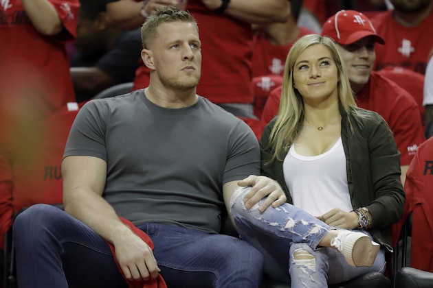 FILE - In this April 16, 2019 photo, Houston Texans' J.J. Watt, left, and his girlfriend, professional soccer player Kealia Ohai attend Game 1 of an NBA basketball first-round playoff series between the Oklahoma City Thunder and Houston Rockets in Houston. Both tweeted word of their engagement Sunday, May 26, 2019, with photos showing Watt down on one knee before Ohai along a waterfront and rocky coast with a beautiful sunset. (AP Photo/David J. Phillip, File)
