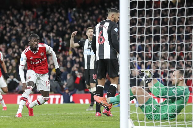 Arsenal's Nicolas Pepe, left, celebrates after scoring his side's second goal during the English Premier League soccer match between Arsenal and Newcastle at the Emirates Stadium in London, Sunday, Feb. 16, 2020.(AP Photo/Frank Augstein)