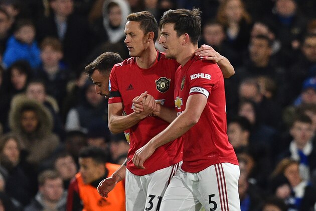 Manchester United's English defender Harry Maguire (R) is congratulated by Manchester United's Serbian midfielder Nemanja Matic (L) after he scores their second goal during the English Premier League football match between Chelsea and Manchester United at Stamford Bridge in London on February 17, 2020. (Photo by Glyn KIRK / AFP) / RESTRICTED TO EDITORIAL USE. No use with unauthorized audio, video, data, fixture lists, club/league logos or 'live' services. Online in-match use limited to 120 images. An additional 40 images may be used in extra time. No video emulation. Social media in-match use limited to 120 images. An additional 40 images may be used in extra time. No use in betting publications, games or single club/league/player publications. /  (Photo by GLYN KIRK/AFP via Getty Images)