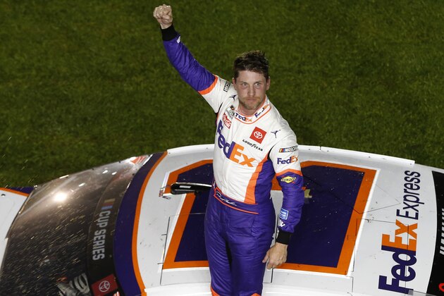 DAYTONA BEACH, FLORIDA - FEBRUARY 17: Denny Hamlin, driver of the #11 FedEx Express Toyota, celebrates after winning the NASCAR Cup Series 62nd Annual Daytona 500 at Daytona International Speedway on February 16, 2020 in Daytona Beach, Florida. (Photo by Brian Lawdermilk/Getty Images)