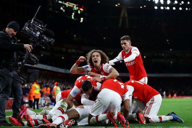 LONDON, ENGLAND - FEBRUARY 16: David Luiz of Arsenal celebrates his sides fourth goal scored by Alexandre Lacazette and team mates during the Premier League match between Arsenal FC and Newcastle United at Emirates Stadium on February 16, 2020 in London, United Kingdom. (Photo by Richard Heathcote/Getty Images)