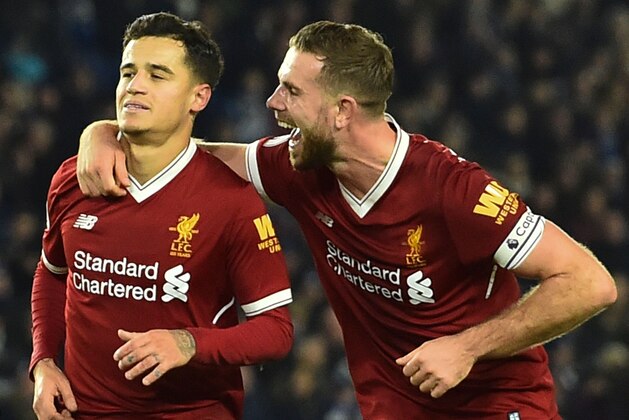 Liverpool's English midfielder Jordan Henderson (R) celebrates with Liverpool's Brazilian midfielder Philippe Coutinho (L) after Liverpool's Brazilian midfielder Philippe Coutinho scored their fourth goal during the English Premier League football match between Brighton and Hove Albion and Liverpool at the American Express Community Stadium in Brighton, southern England on December 2, 2017. / AFP PHOTO / Glyn KIRK / RESTRICTED TO EDITORIAL USE. No use with unauthorized audio, video, data, fixture lists, club/league logos or 'live' services. Online in-match use limited to 75 images, no video emulation. No use in betting, games or single club/league/player publications.  /         (Photo credit should read GLYN KIRK/AFP via Getty Images)