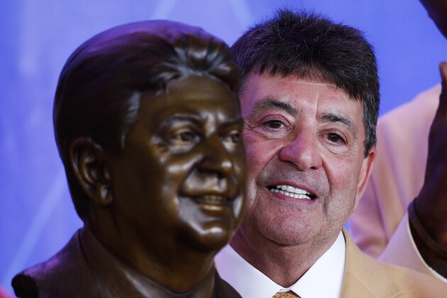 Former NFL owner Edward J. DeBartolo Jr., poses with his bust during an induction ceremony at the Pro Football Hall of Fame Saturday, Aug. 6, 2016, in Canton, Ohio.  (AP Photo/Ron Schwane)