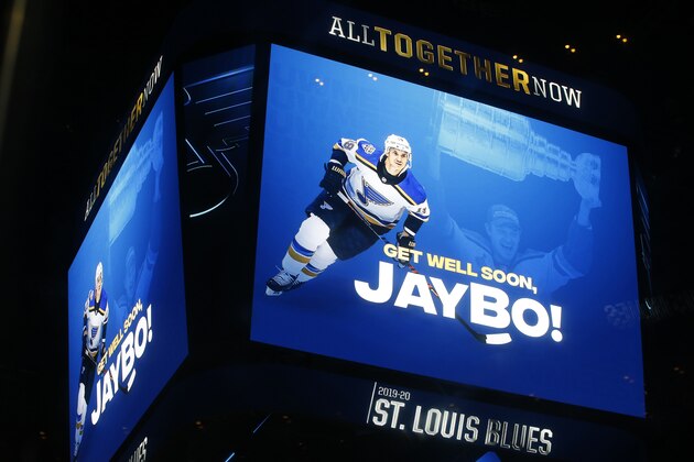 The scoreboard sends well wishes to St. Louis Blues' Jay Bouwmeester prior to the start of an NHL hockey game against the Nashville Predators Saturday, Feb. 15, 2020, in St. Louis. Bouwmeester suffered a cardiac episode while on the bench during a game Tuesday, Feb. 11, 2020, in Anaheim, Calif. (AP Photo/Billy Hurst)