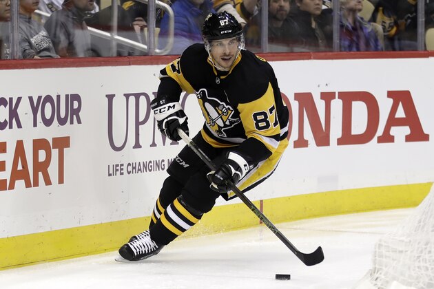 Pittsburgh Penguins' Sidney Crosby looks to pass the puck during the second period of the team's NHL hockey game against the Toronto Maple Leafs in Pittsburgh, Tuesday, Feb. 18, 2020. Crosby had a goal and three assists in the Penguins' 5-2 win. (AP Photo/Gene J. Puskar)
