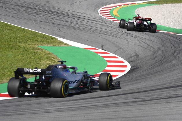 BARCELONA, SPAIN - FEBRUARY 19: Robert Kubica of Poland driving the (88) Alfa Romeo Racing C39 Ferrari leads Valtteri Bottas driving the (77) Mercedes AMG Petronas F1 Team Mercedes W11 on track during day one of Formula 1 Winter Testing at Circuit de Barcelona-Catalunya on February 19, 2020 in Barcelona, Spain. (Photo by Rudy Carezzevoli/Getty Images)