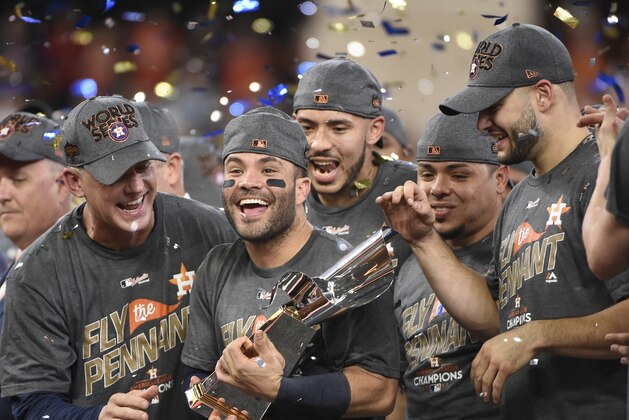 Houston Astros' Jose Altuve holds up the championship trophy after Game 7 of baseball's American League Championship Series against the New York Yankees Saturday, Oct. 21, 2017, in Houston. The Astros won 4-0 to win the series. (AP Photo/Eric Christian Smith)