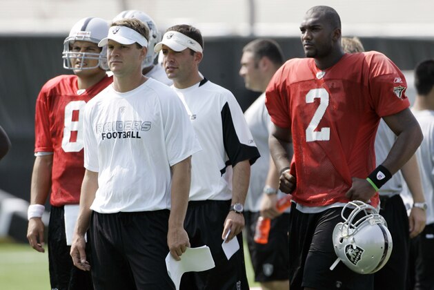 ** FILE ** In this July 24, 2008 file photo, Oakland Raiders head coach Lane Kiffin, second from left, quarterbacks Marques Tuiasosopo, left, and JaMarcus Russell (2) watch from the sidelines during workouts at their football training camp in Napa, Calif. The focus of the third exhibition game against the Arizona Cardinals on Saturday night, Aug. 23, 2008, will be on what Russell and the receivers can do through the air. (AP Photo/Eric Risberg,file)