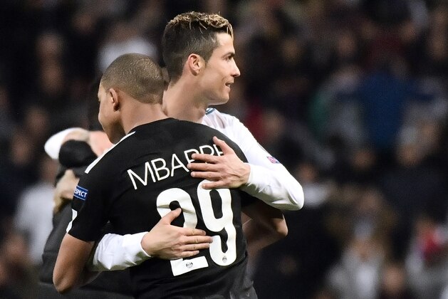 Real Madrid's Portuguese forward Cristiano Ronaldo (R) hugs Paris Saint-Germain's French forward Kylian Mbappe during the UEFA Champions League round of sixteen first leg football match Real Madrid CF against Paris Saint-Germain (PSG) at the Santiago Bernabeu stadium in Madrid on February 14, 2018.   / AFP PHOTO / CHRISTOPHE SIMON        (Photo credit should read CHRISTOPHE SIMON/AFP via Getty Images)
