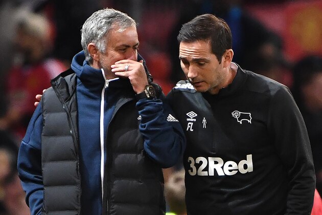 Manchester United's Portuguese manager Jose Mourinho (L) talks with Derby's English manager Frank Lampard at the half-time break in the English League Cup third round football match between Manchester United and Derby County at Old Trafford in Manchester, north west England, on September 25, 2018. (Photo by Paul ELLIS / AFP) / RESTRICTED TO EDITORIAL USE. No use with unauthorized audio, video, data, fixture lists, club/league logos or 'live' services. Online in-match use limited to 120 images. An additional 40 images may be used in extra time. No video emulation. Social media in-match use limited to 120 images. An additional 40 images may be used in extra time. No use in betting publications, games or single club/league/player publications. /         (Photo credit should read PAUL ELLIS/AFP via Getty Images)