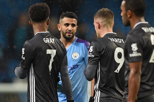 Manchester City's Algerian midfielder Riyad Mahrez (2nd L) talks with former teammate Leicester City's English striker Jamie Vardy on the pitch after the English Premier League football match between Manchester City and Leicester City at the Etihad Stadium in Manchester, north west England, on December 21, 2019. - Manchester City won the game 3-1. (Photo by Oli SCARFF / AFP) / RESTRICTED TO EDITORIAL USE. No use with unauthorized audio, video, data, fixture lists, club/league logos or 'live' services. Online in-match use limited to 120 images. An additional 40 images may be used in extra time. No video emulation. Social media in-match use limited to 120 images. An additional 40 images may be used in extra time. No use in betting publications, games or single club/league/player publications. /  (Photo by OLI SCARFF/AFP via Getty Images)