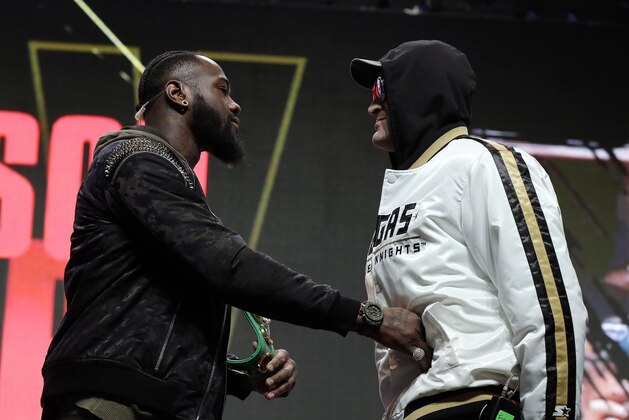 Deontay Wilder, left, shoves Tyson Fury, of England, during a face off for photographers at a news conference for their upcoming WBC heavyweight championship boxing match, Wednesday, Feb. 19, 2020, in Las Vegas. (AP Photo/Isaac Brekken) Deontay Wilder, left, shoves Tyson Fury, of England, during a face off for photographers at a news conference for their upcoming WBC heavyweight championship boxing match, Wednesday, Feb. 19, 2020, in Las Vegas. (AP Photo/Isaac Brekken)