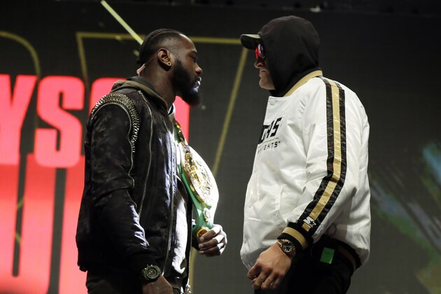 Tyson Fury, of England, right, and Deontay Wilder face off for photographers during a news conference for their upcoming WBC heavyweight championship boxing match, Wednesday, Feb. 19, 2020, in Las Vegas. (AP Photo/Isaac Brekken) Tyson Fury, of England, right, and Deontay Wilder face off for photographers during a news conference for their upcoming WBC heavyweight championship boxing match, Wednesday, Feb. 19, 2020, in Las Vegas. (AP Photo/Isaac Brekken)