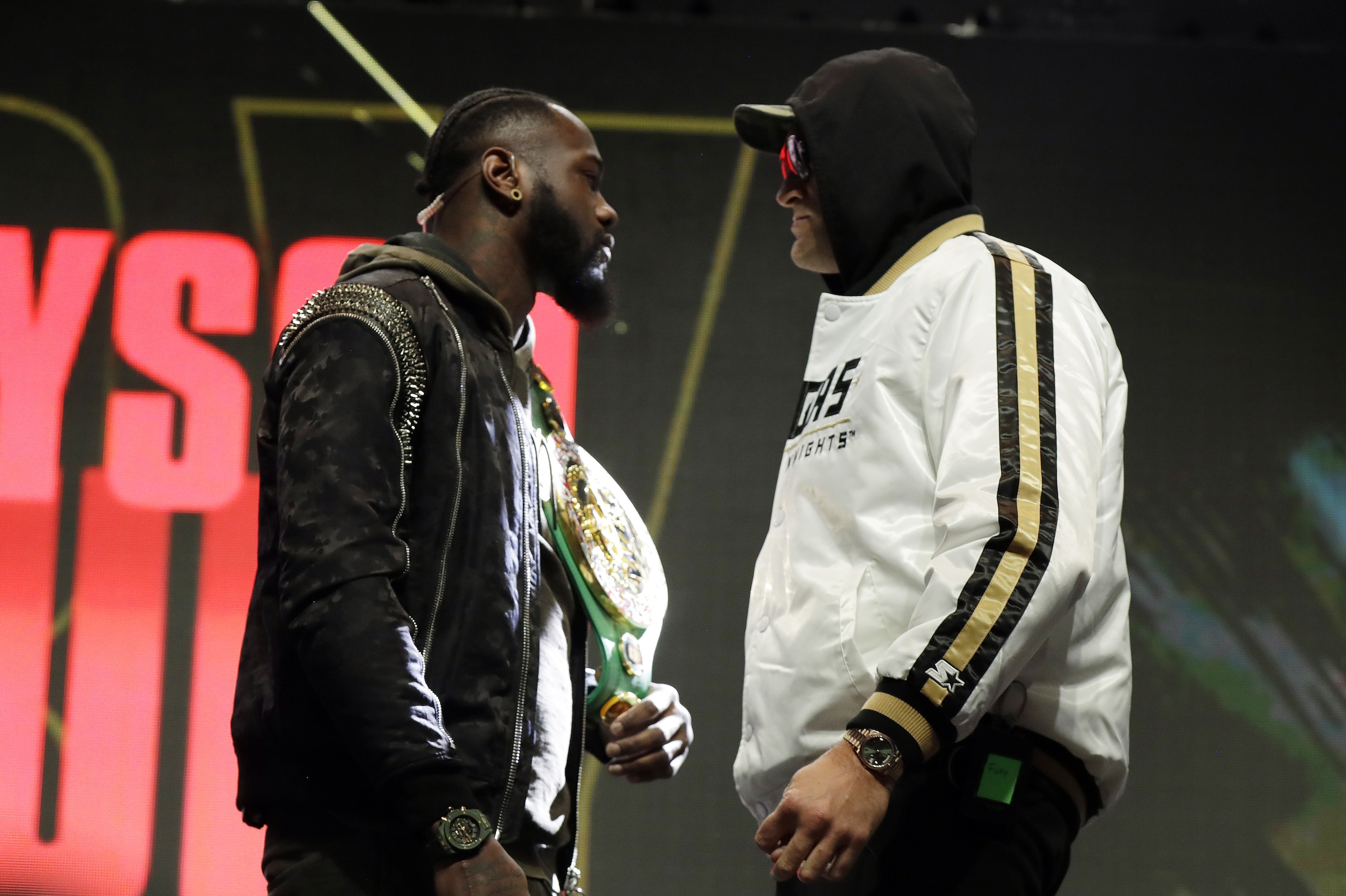 Tyson Fury, of England, right, and Deontay Wilder face off for photographers during a news conference for their upcoming WBC heavyweight championship boxing match, Wednesday, Feb. 19, 2020, in Las Vegas. (AP Photo/Isaac Brekken)