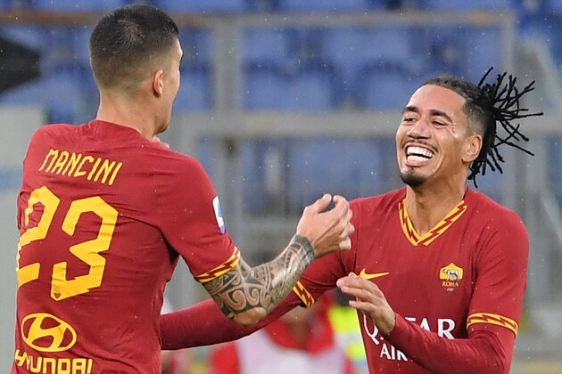 AS Roma's Italian defender Gianluca Mancini (L) celebrates with AS Roma's English defender Chris Smalling after scoring his team's second goal during the Italian Serie A football match Roma vs Brescia on November 24, 2019 at the Olympic stadium in Rome. (Photo by Andreas SOLARO / AFP) (Photo by ANDREAS SOLARO/AFP via Getty Images)