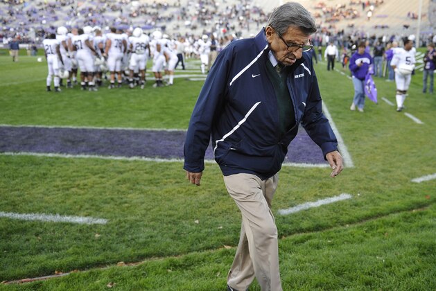 FILE - In this Oct. 22, 2011, file photo, Penn State coach Joe Paterno walks off the field before an NCAA college football game against Northwestern in Evanston, Ill. A proposed settlement, announced Friday, Jan. 16, 2015, by the NCAA, will give Penn State back 112 football team wins that were vacated two years ago in the Jerry Sandusky child molestation scandal.  If approved, the new agreement also would restore former coach Paterno's status as the winningest coach in major college football history with 409 victories.  (AP Photo/Jim Prisching, File)