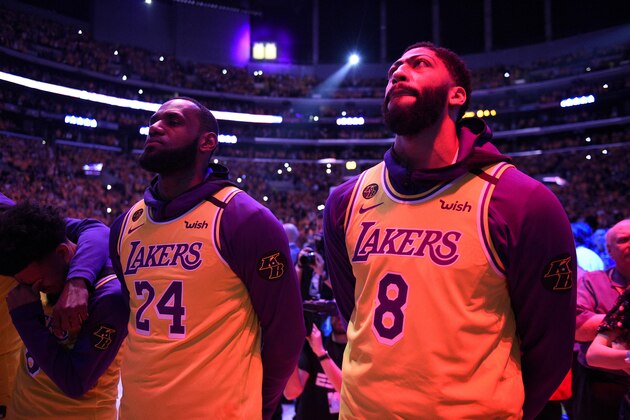 Los Angeles Lakers' LeBron James, left, and Anthony Davis stand for the national anthem for the llate Kobe Bryant, prior the Lakers' NBA basketball game against the Portland Trail Blazers in Los Angeles, Friday, Jan. 31, 2020. (AP Photo/Kelvin Kuo)