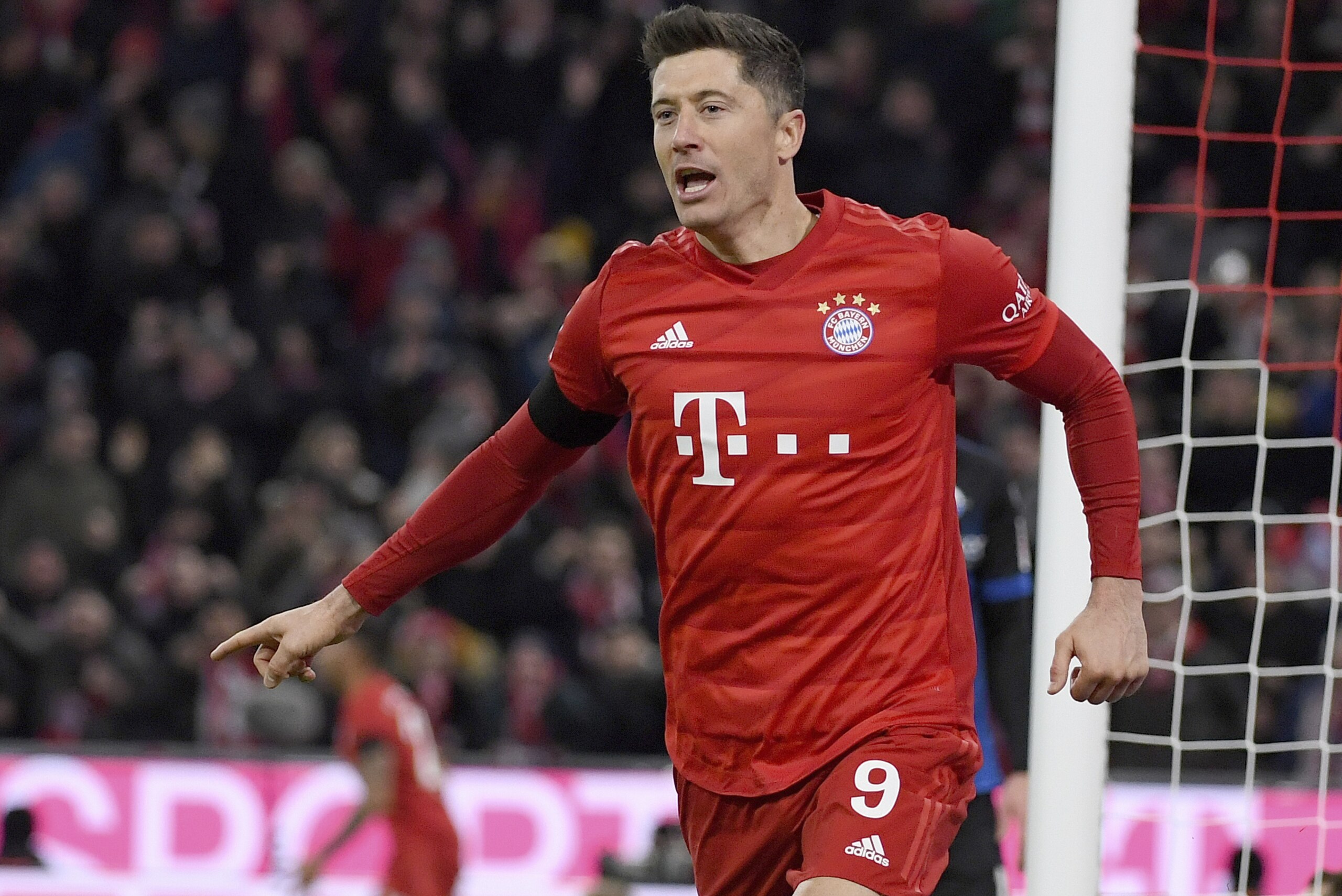 Munich's Robert Lewandowski celebrates after scoring his side third goal during the German Bundesliga soccer match between Bayern Minich and SC Paderborn 07 in Munich, Germany, Friday, Feb. 21, 2020. ( Peter Kneffel/dpa via AP)