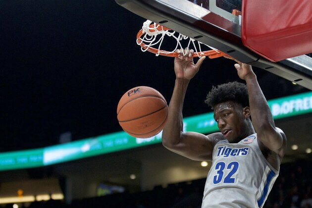 Memphis center James Wiseman dunks next to Oregon forward Shakur Juiston during the second half of an NCAA college basketball game in Portland, Ore., Tuesday, Nov. 12, 2019. Oregon won 82-74. (AP Photo/Craig Mitchelldyer)