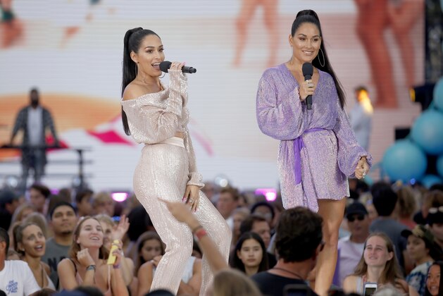 Nikki Bella, left, and Brie Bella introduce a performance by Blanco Brown at the Teen Choice Awards on Sunday, Aug. 11, 2019, in Hermosa Beach, Calif. (Photo by Danny Moloshok/Invision/AP)